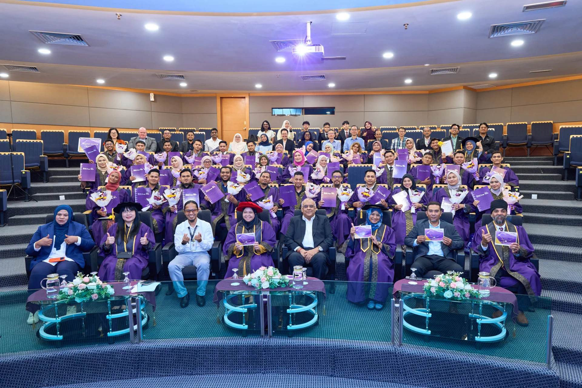 Group photo of graduates and leadership